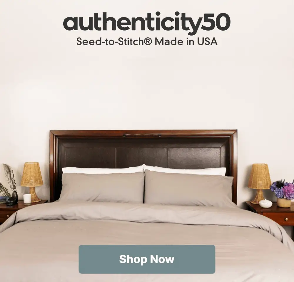 Bed made with Heritage American Sheets with the overlaying text: Carolina Gray sheets are back in stock! Click or tap to shop now.