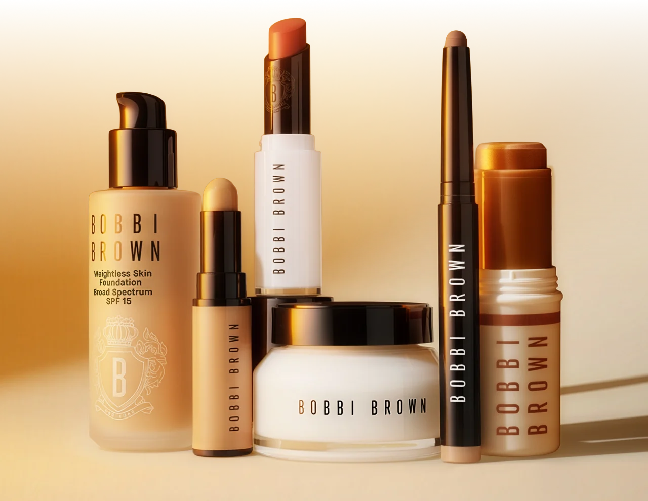 Bobbi Brown bestsellers lined up on a gold and cream gradient background.