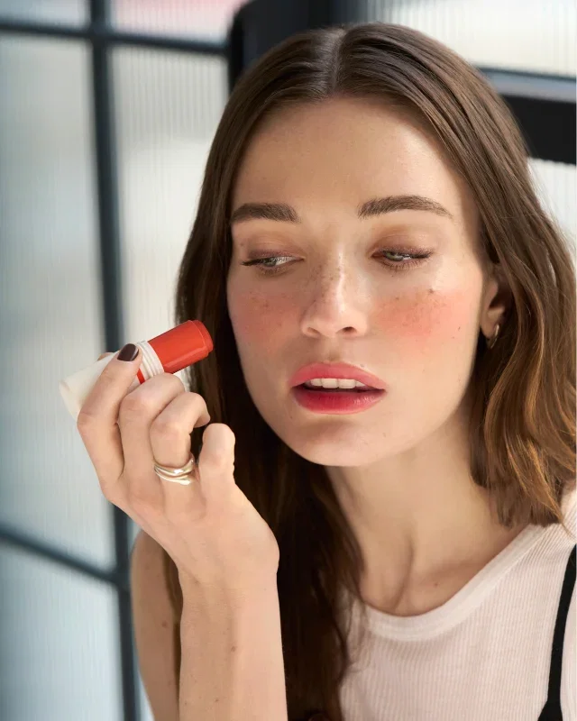 Close-up of a woman applying Skin Enhancer Multistick