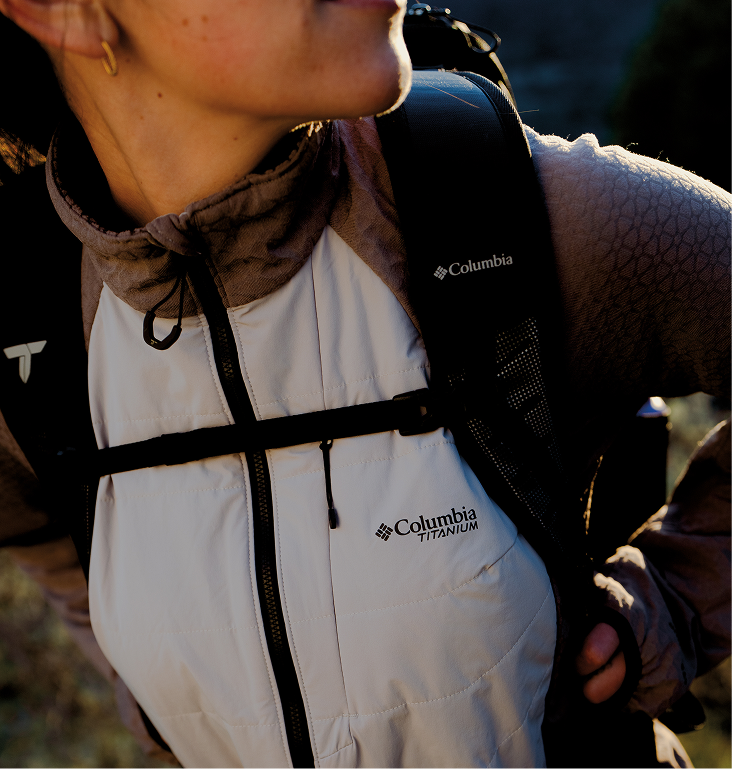 A close-up of a woman backpacking wile wearing a Columbia Titanium softshell jacket.