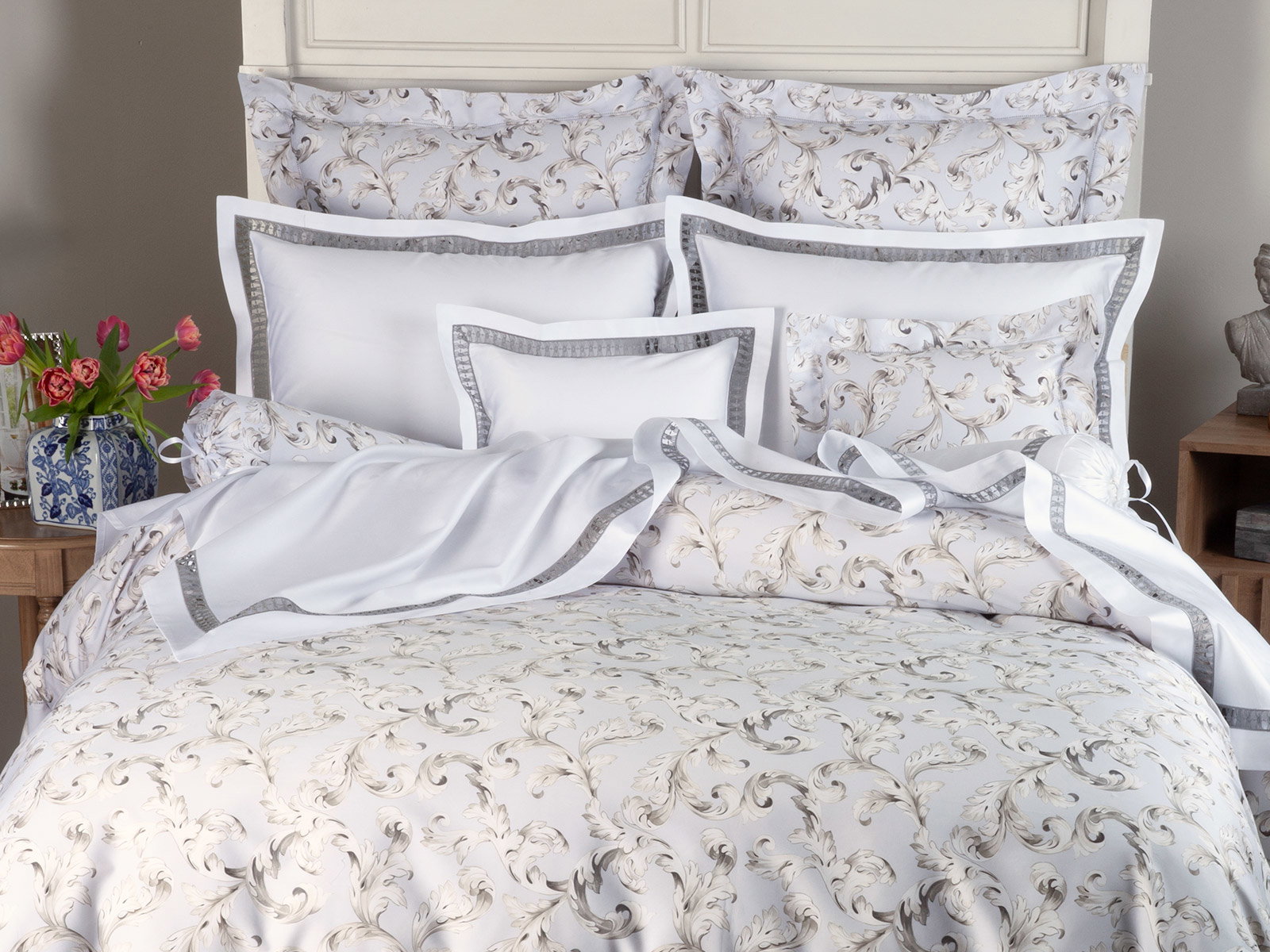 Whispering Acanthus Shown with Atelier) Silky-soft modern luxury, 300 thread count Egyptian cotton sateen bedding, made in Italy and finished with a minimalist hemstitched border. 