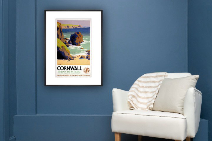 Blue room with white chair and GWR Cornwall poster