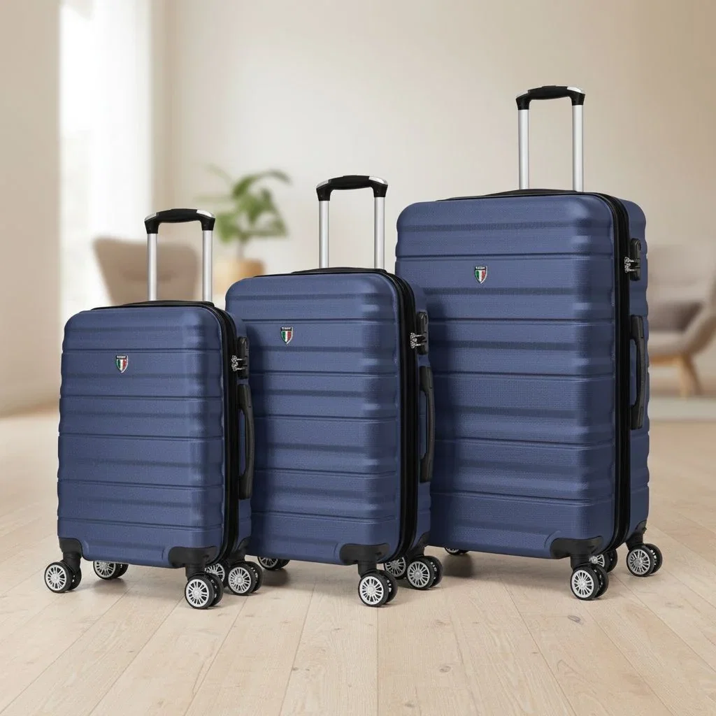 Three navy blue hardside rolling suitcases in small, medium, and large sizes displayed indoors with chrome handles and wheels.