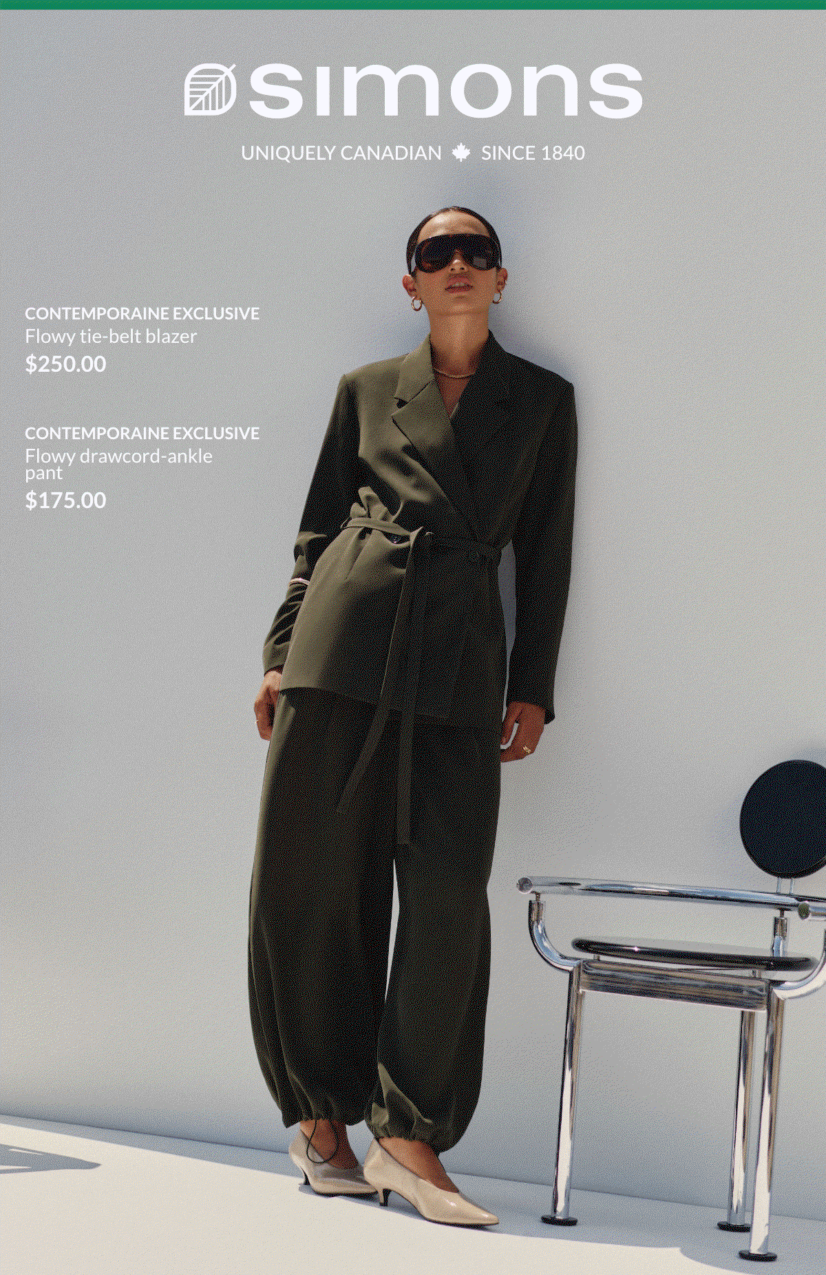 Woman wearing a tie-belt jacket at 250$ and a drawcord-ankle loose pant at 175$.