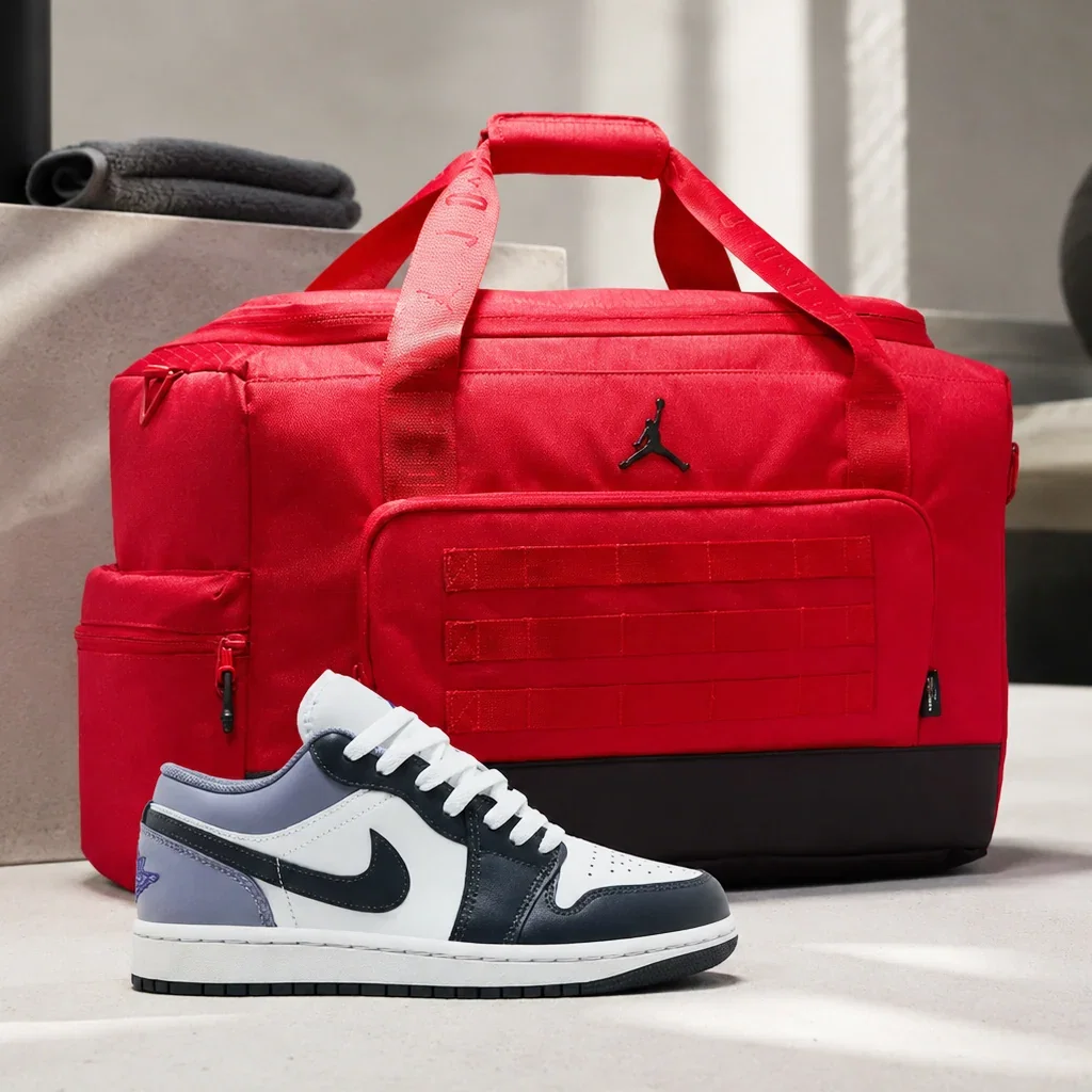 Air Jordan red duffle bag and black-white sneaker displayed on white surface with folded towels