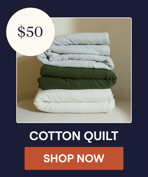 A stack of the Mist, Moss, and Pearl Cotton Quilt