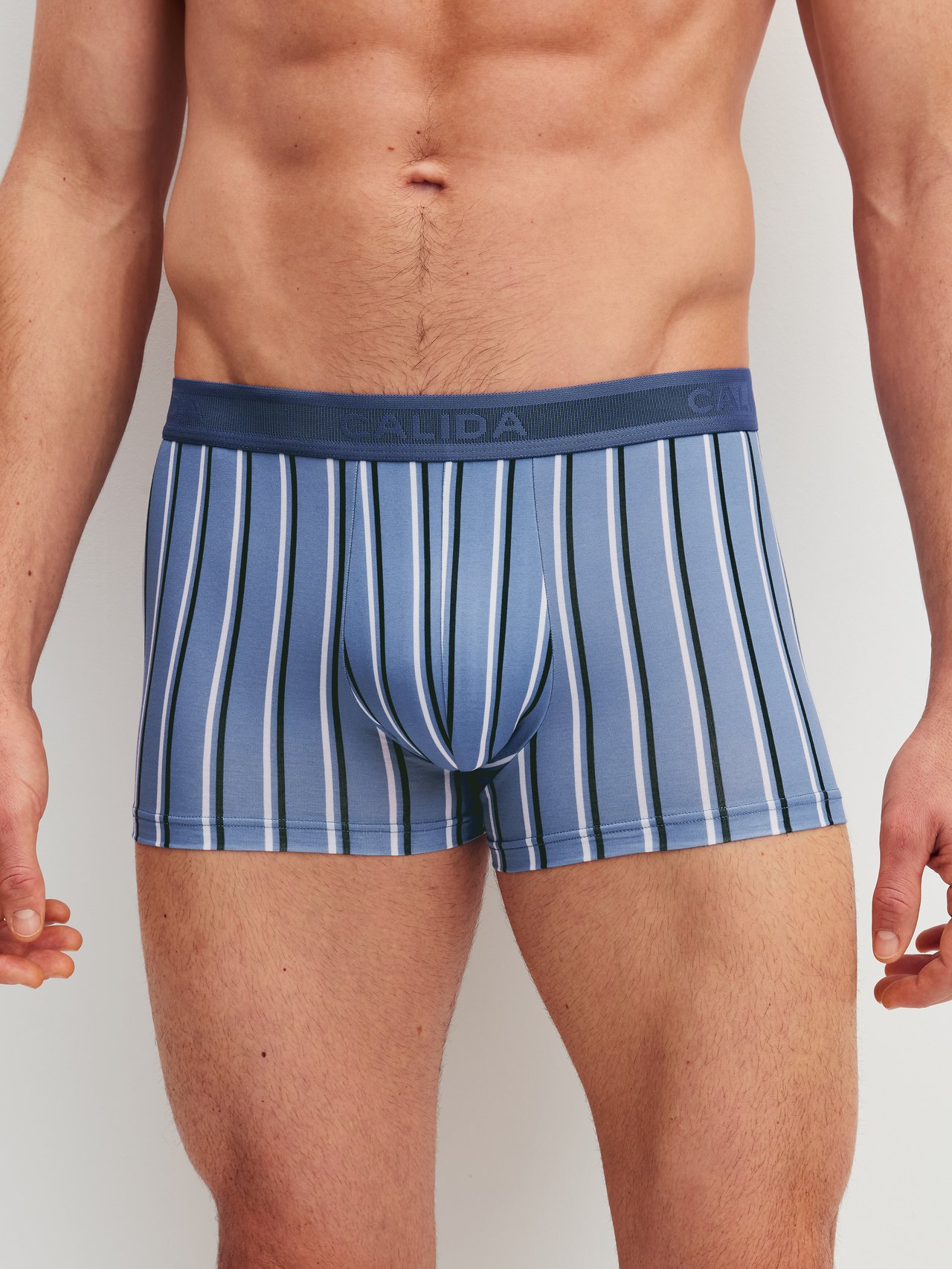 Men model is wearing Boxer brief made of Pima® Cotton in Blue, Striped from the Grafic Cotton series by CALIDA, Front view