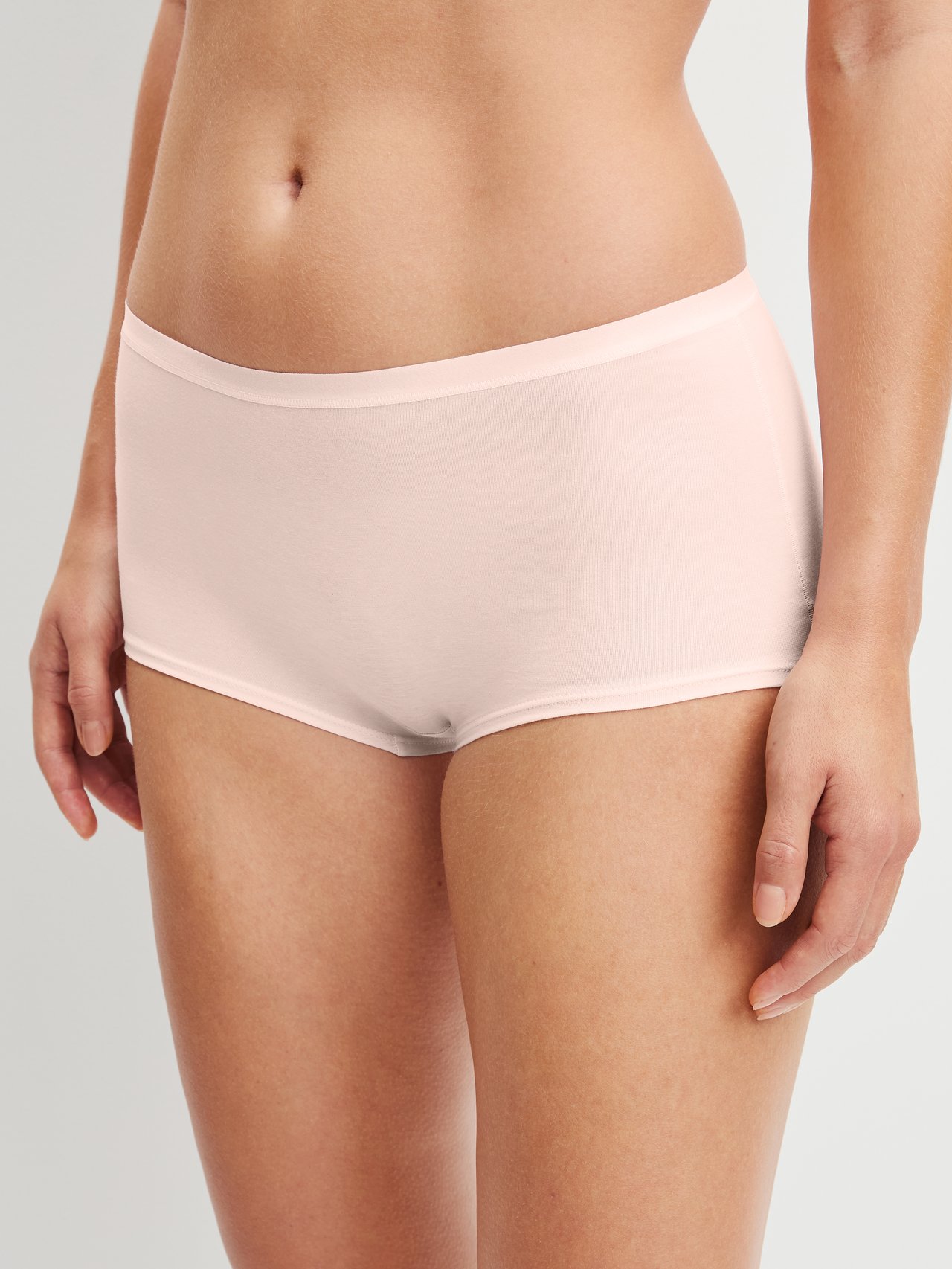 Women model is wearing Shorty regular cut made of Cotton in Pink, Unicoloured from the Natural Comfort series by CALIDA, Back view