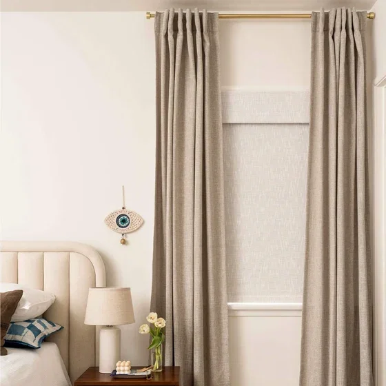 Custom curtains and woven shade in a bedroom