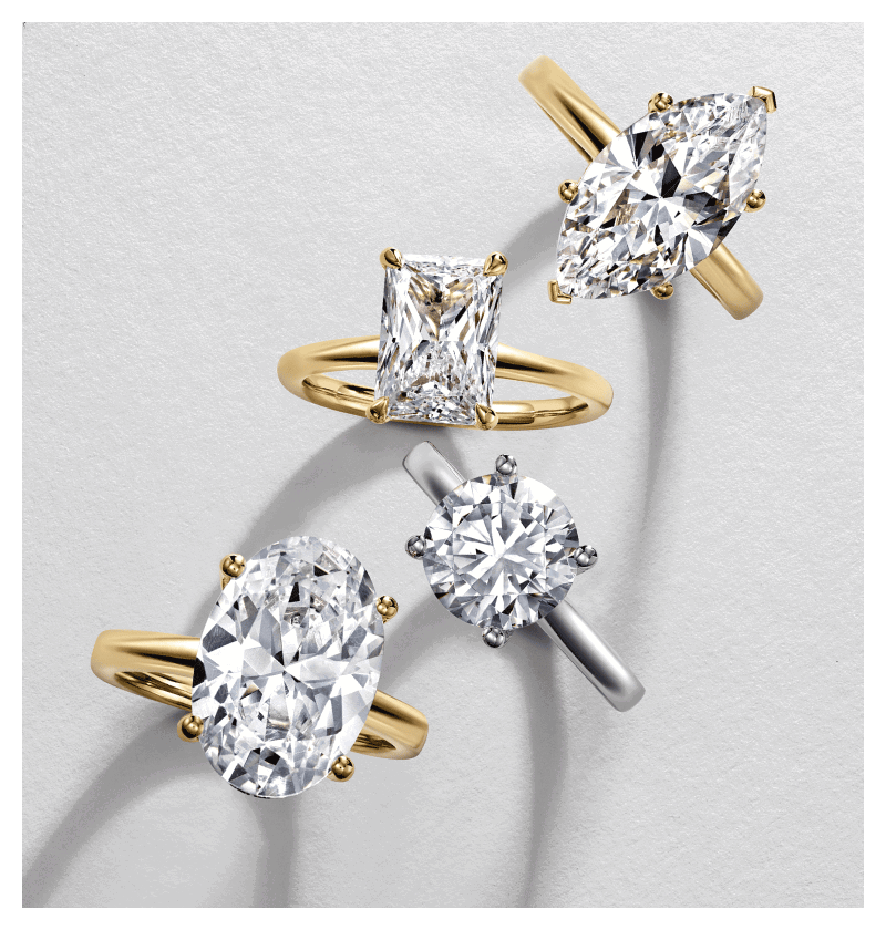 White and yellow gold diamond solitaire engagement rings featuring different stone shapes.