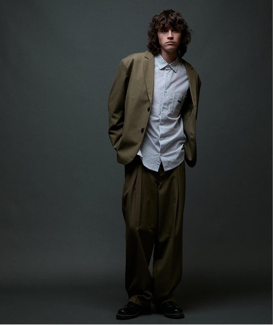 Model posing in a dark background wearing all Obey fall collection for men