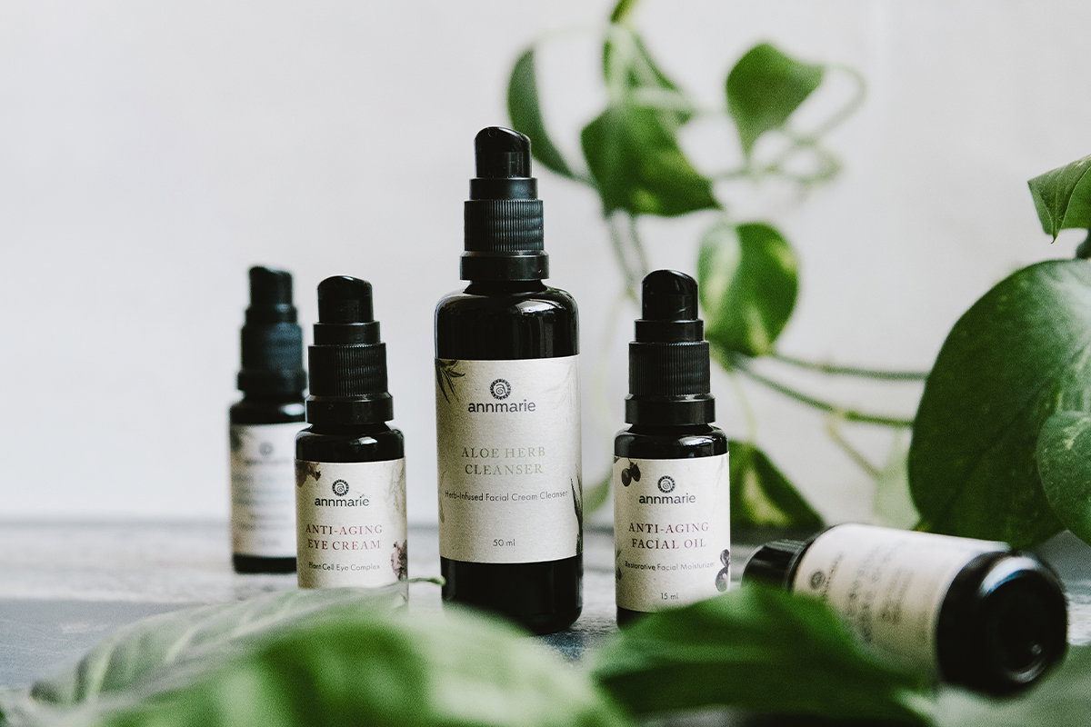 Annmarie holding herbs in a basic for the Divine Woman Elixir