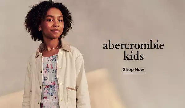 Image of a girl in a floral dress a collared jacket. abercrombie kids logo. Shop now.