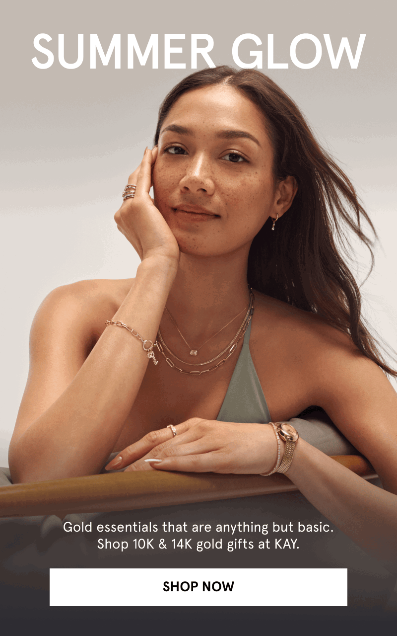 A model wearing layered gold necklaces, rings, bracelet and watch. Summer Glow. 10K & 14K gold gifts at Kay. Click shop now.