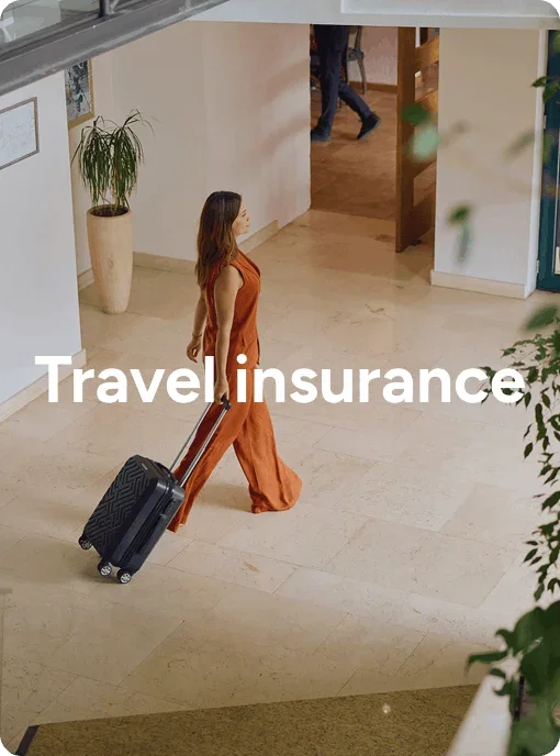 Person walking through a lobby with a suitcase