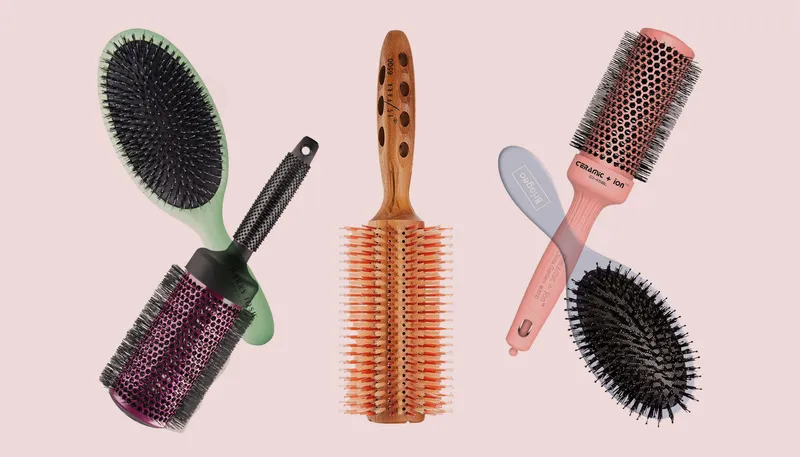 Hair brushes overlapping on a light pink background