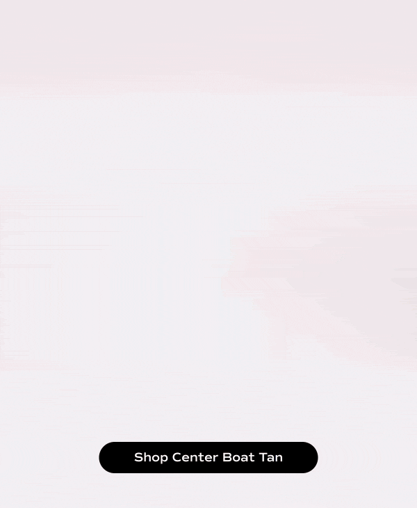 A gray background with a video of someone walking in and out of the frame in the Center III Suede Boat Shoes in tan paired with brown ankle-length pants.  Shop Center Boat Tan