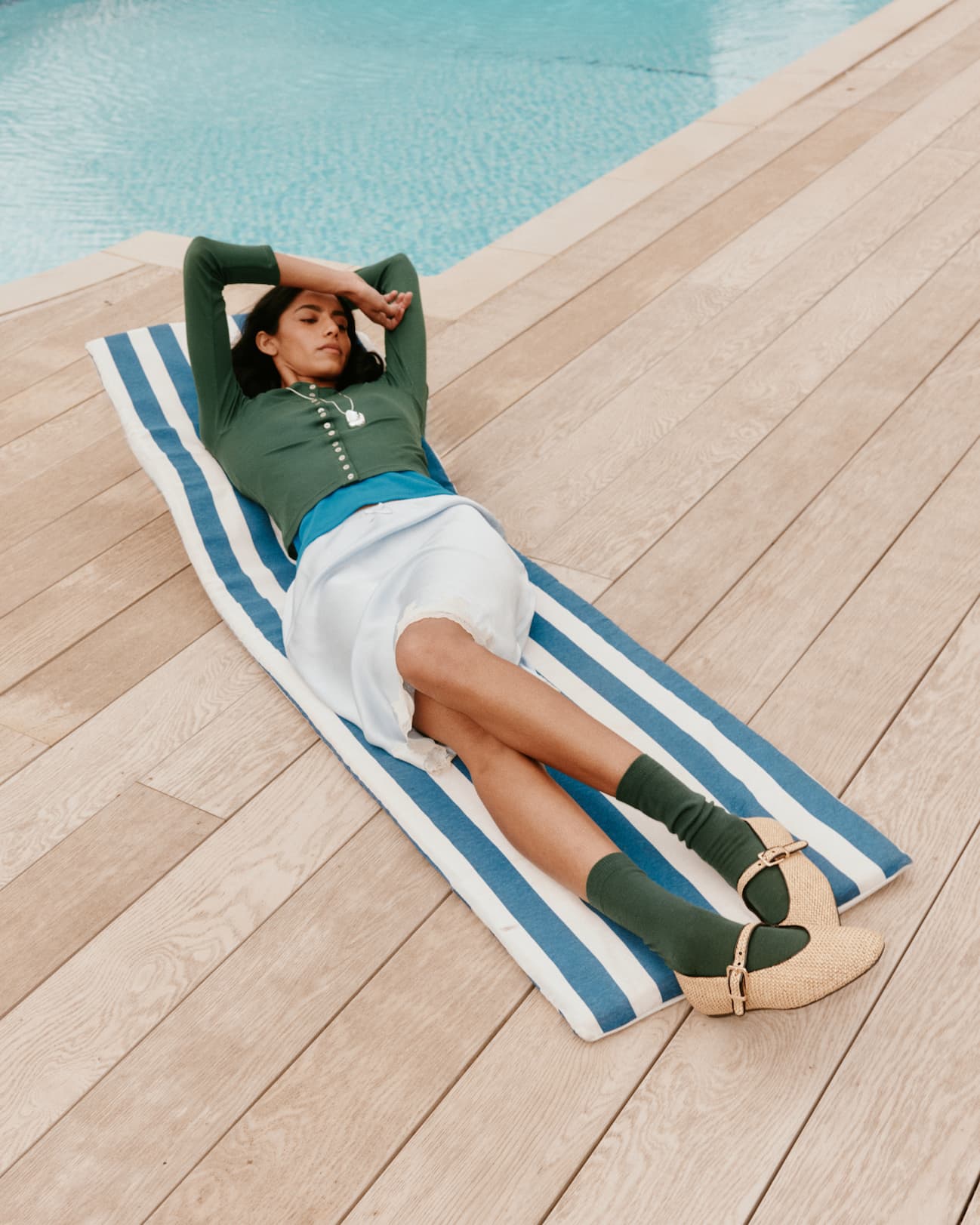 Model on stripey towel wearing Glen Green Bamboo socks