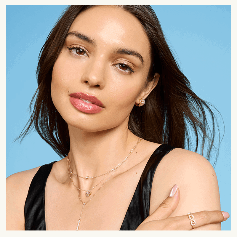 Model in assortment of dainty gold jewelry styles with lab-grown diamond accents & details.