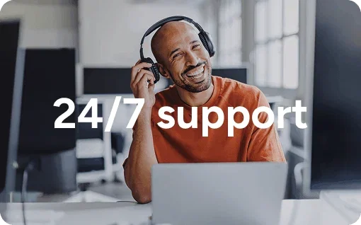 Person wearing headphones at a laptop