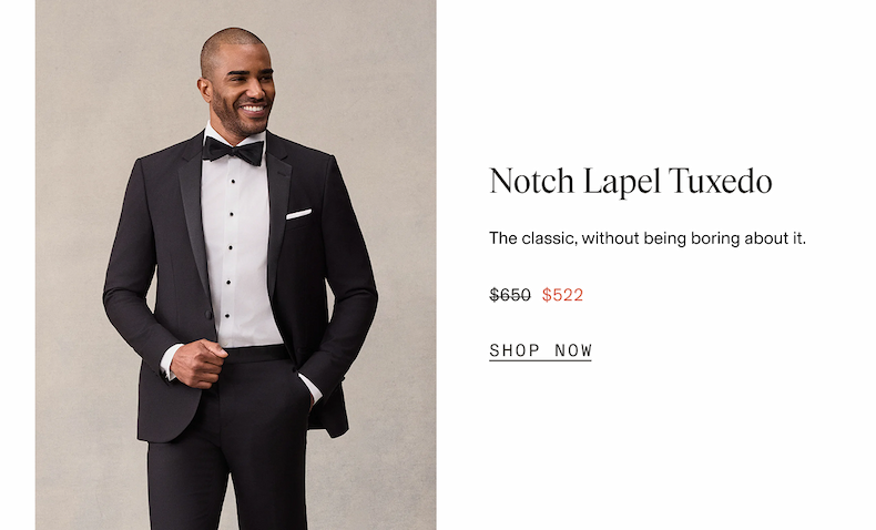 Man wearing a black tuxedo with a black bow tie, white dress shirt, and white pocket square, smiling and looking off to the side with one hand in his pocket. Notch Lapel Tuxedo. The classic, without being boring about it. $650 $522 SHOP NOW