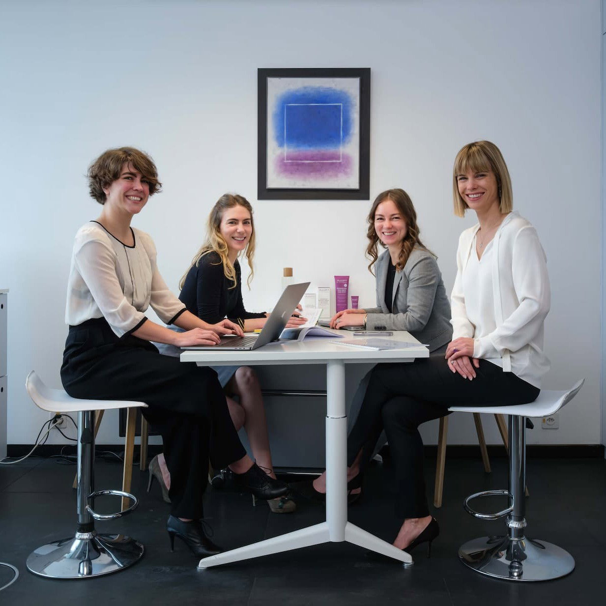 An image of the Polla sisters sitting at a desk smiling into the camera.