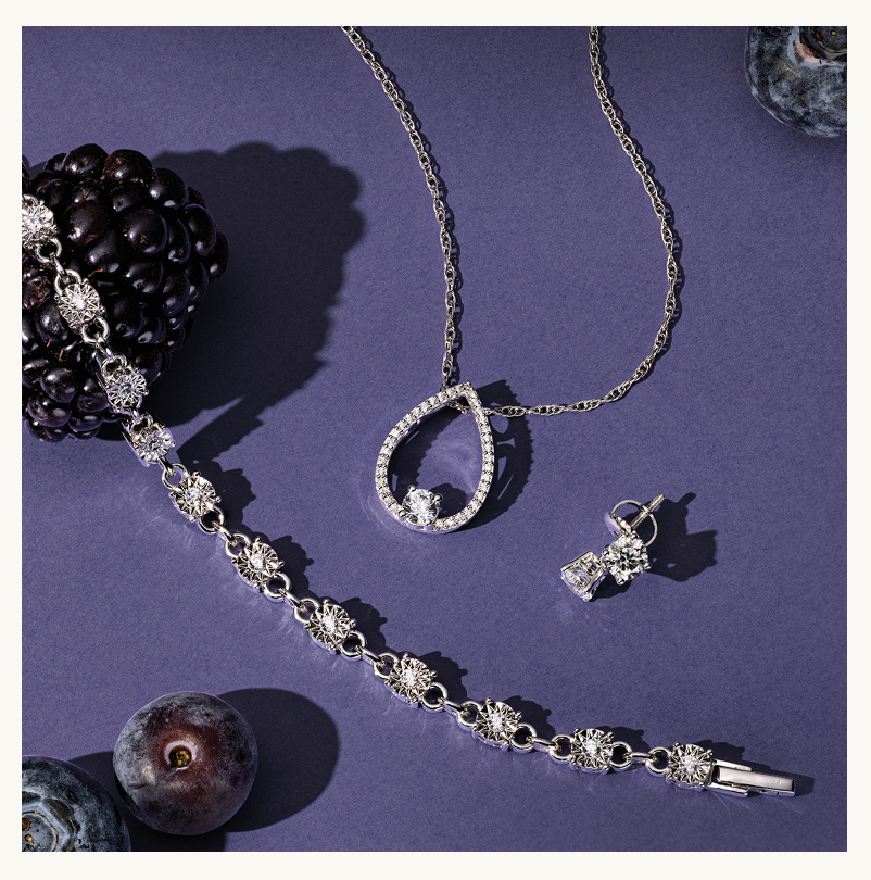 Diamond pendant & bracelet & studs, next to blackberries & blueberries. Click here to shop now