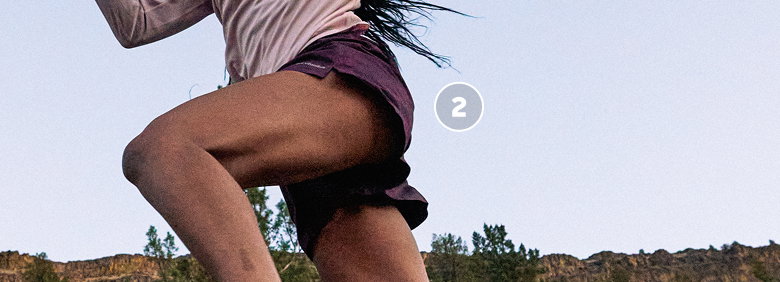 A woman runner leaping.
