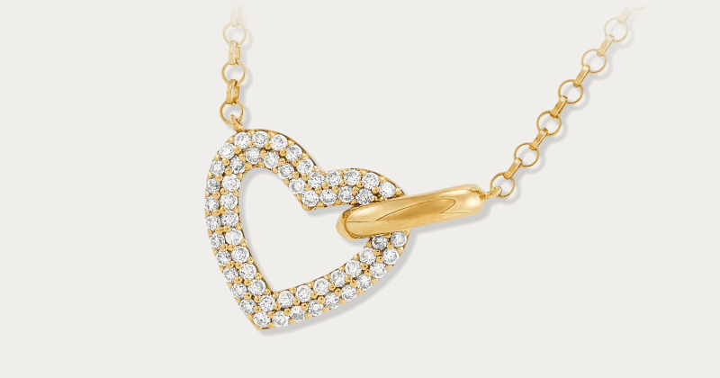 Yellow gold open-heart pendant with pavé diamond accents on a dainty chain.