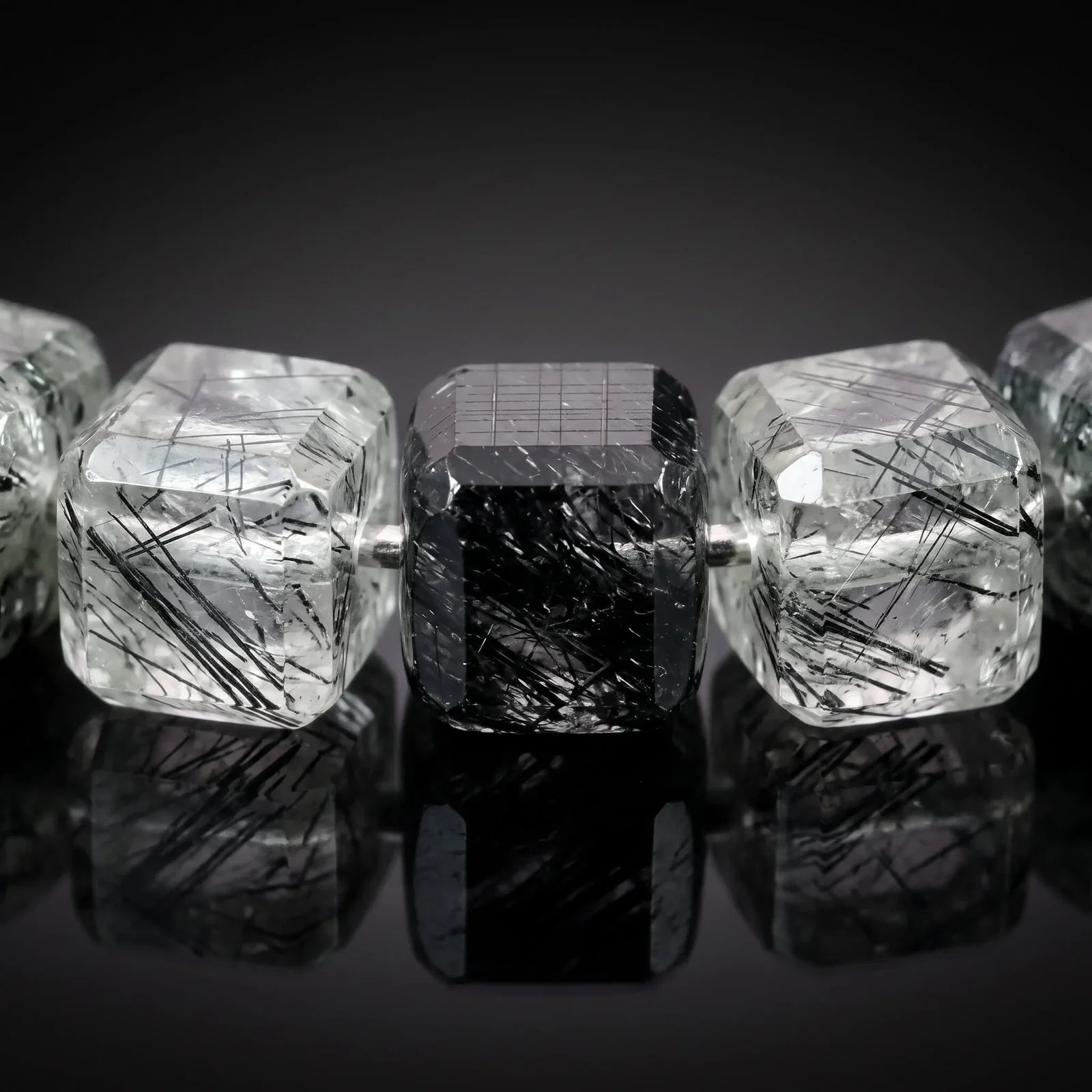 Close-up of black tourmaline crystals inside the Tourmalinated Quartz Cube Bracelet