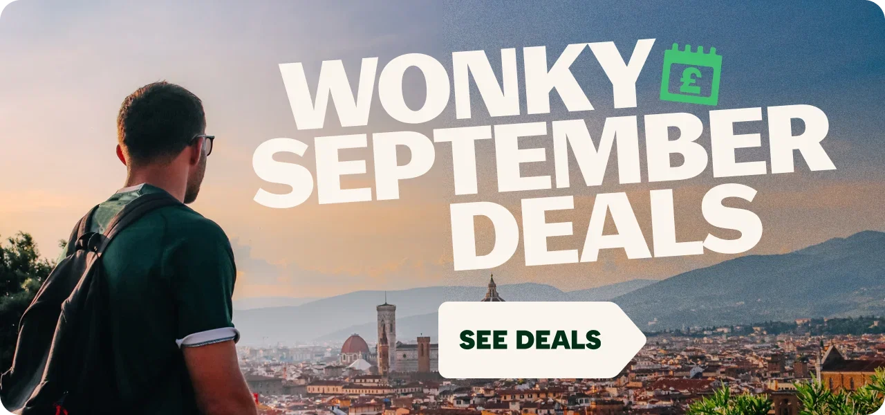 Promotional travel graphic featuring a person with a backpack overlooking a historic city at sunset with mountains in the background. Large white text reads 'WONKY SEPTEMBER DEALS' alongside a green calendar icon with a pound symbol. A white arrow-shaped button at the bottom reads 'SEE DEALS'.