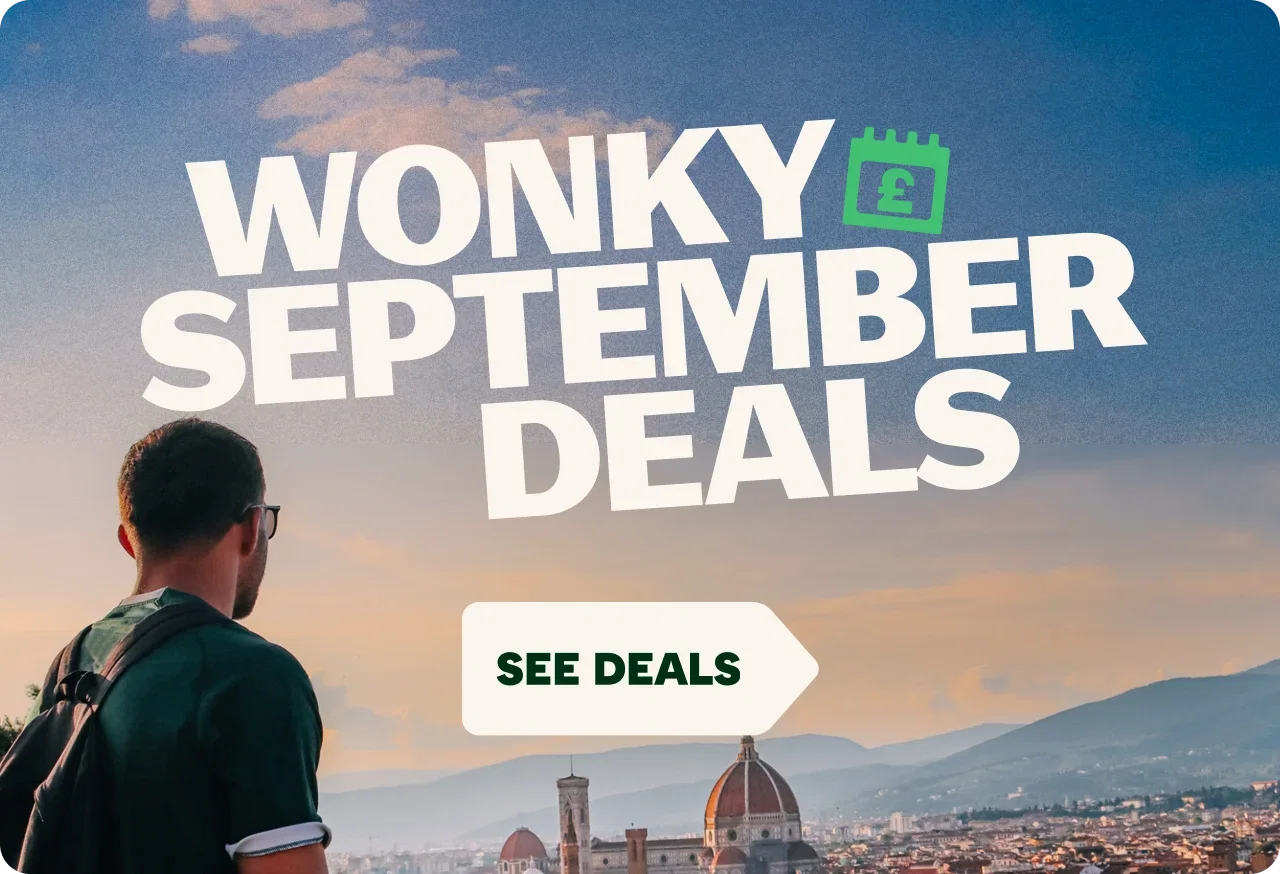Promotional travel graphic featuring a person with a backpack overlooking a historic city at sunset with mountains in the background. Large white text reads 'WONKY SEPTEMBER DEALS' alongside a green calendar icon with a pound symbol. A white arrow-shaped button at the bottom reads 'SEE DEALS'.