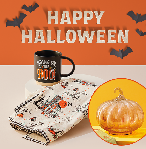Happy Halloween lettering with bats, bring on the boo mug, vintage blanket and glass pumpkin.