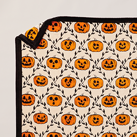 Vintage blanket with jack-o’-lanterns.