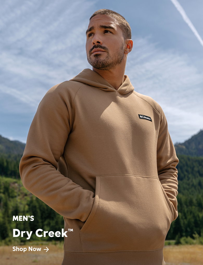 A man wearing a brown and black sweat set outside with text: Men's Agate Rock™