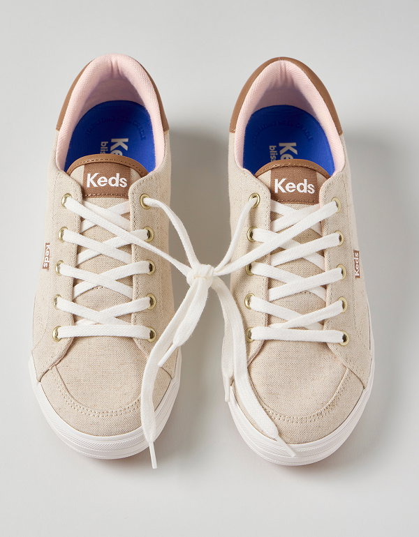 An overhead view of a pair of the Center III Undyed Canvas Lace-Ups in natural with the laces tied together.  Love-Forever Lace-Ups Shop the Center