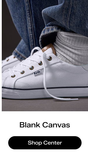 A side view of the Center III Canvas Lace-Up in white/navy paired with baggy denim and ribbed socks.  Blank Canvas Shop the Center