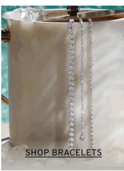Diamond tennis bracelets draped on an ice bucket. Click to Shop Bracelets