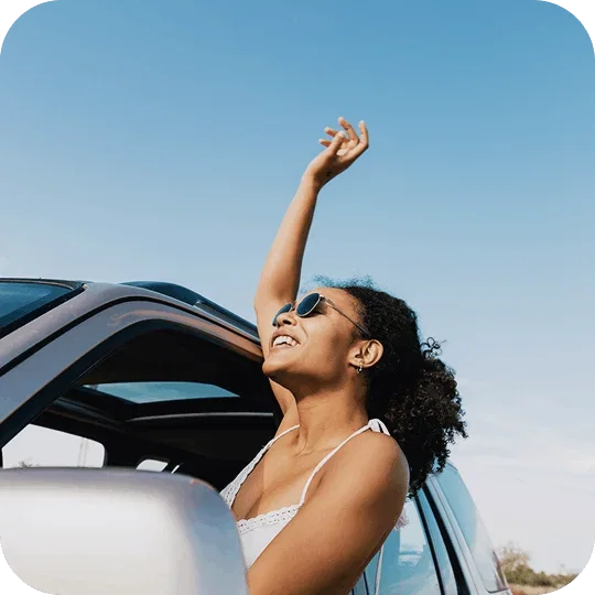 Person leaning out a car window