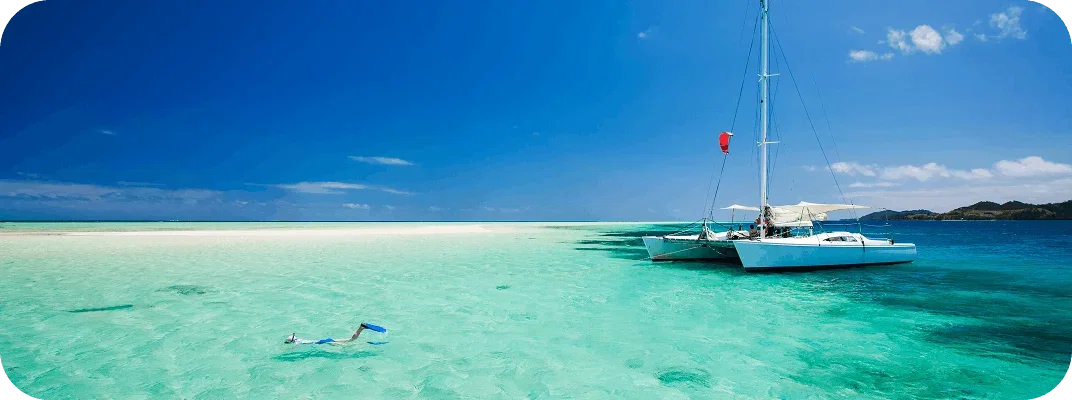Person snorkelling in clear turquoise water