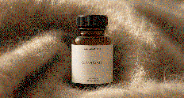 GIF of diffuser oil bottles on green tea leaves and cashmere musk