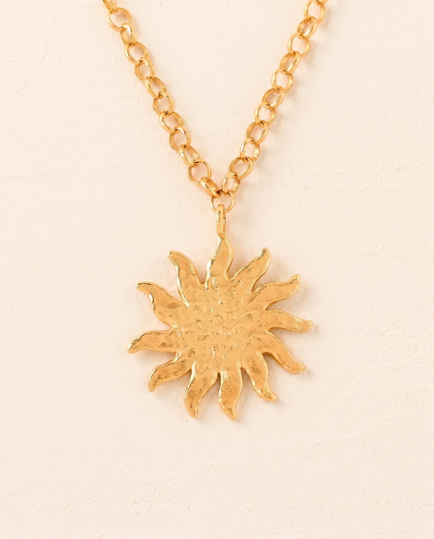 Helio necklace: hammered gold sun pendant on a chain-link necklace