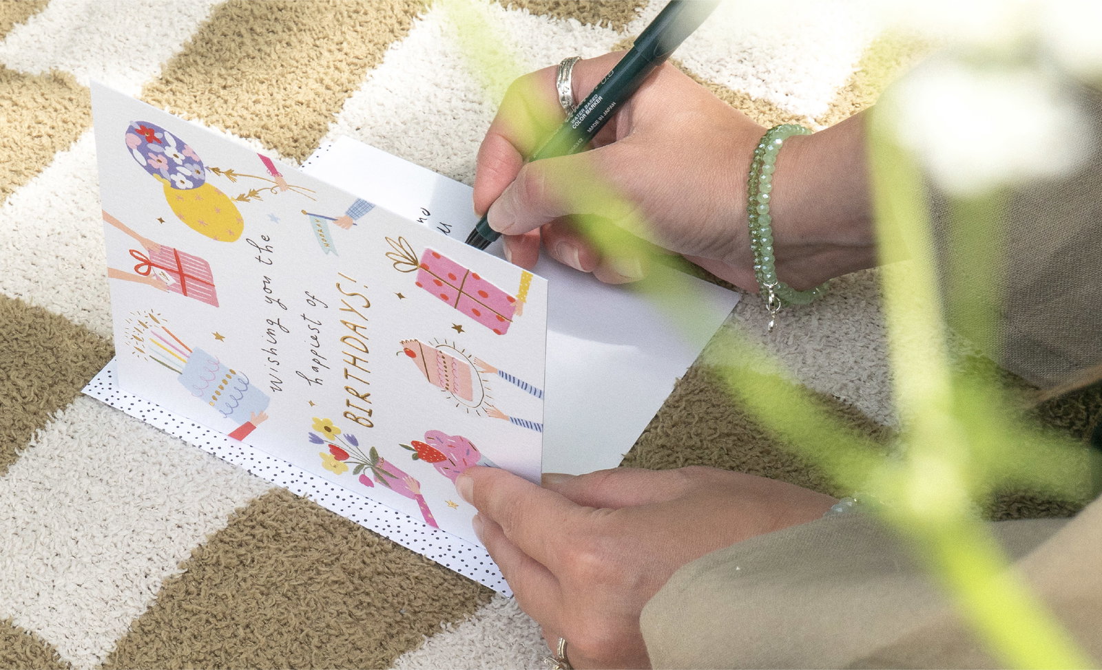 A handwritten Whistlefish birthday card being personalised with a message. Whistlefish offers handwritten card services to help customers send meaningful greetings directly to loved ones.