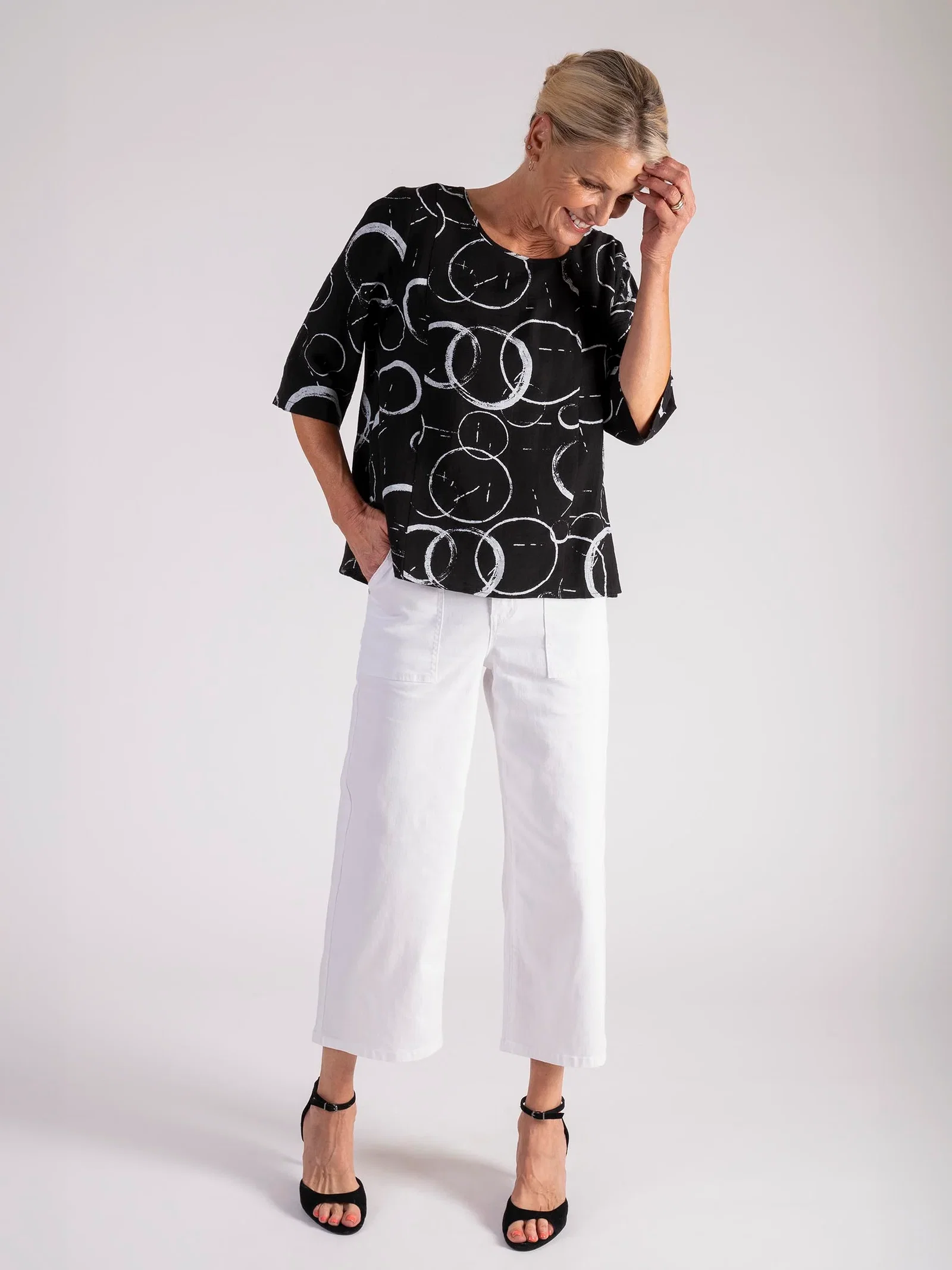 Image of Black Circle Print Roundneck Top with Stepped Hemline
