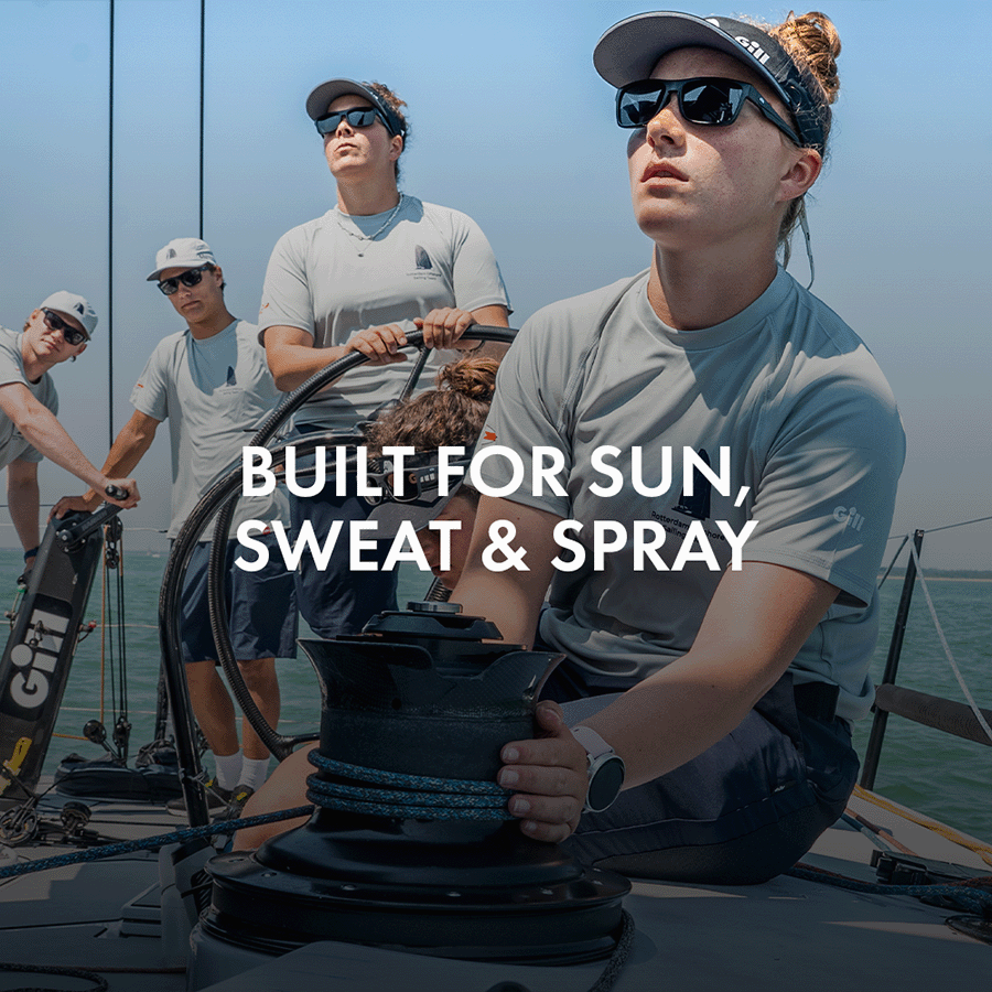 Women on a race boat at the helm and navigating
