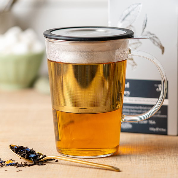 image of pao mug infuser with spoon of loose leaf tea