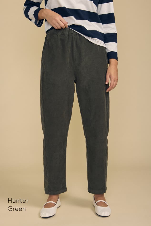 Image shows a model wearing the Laney Pants in Hunter Green.