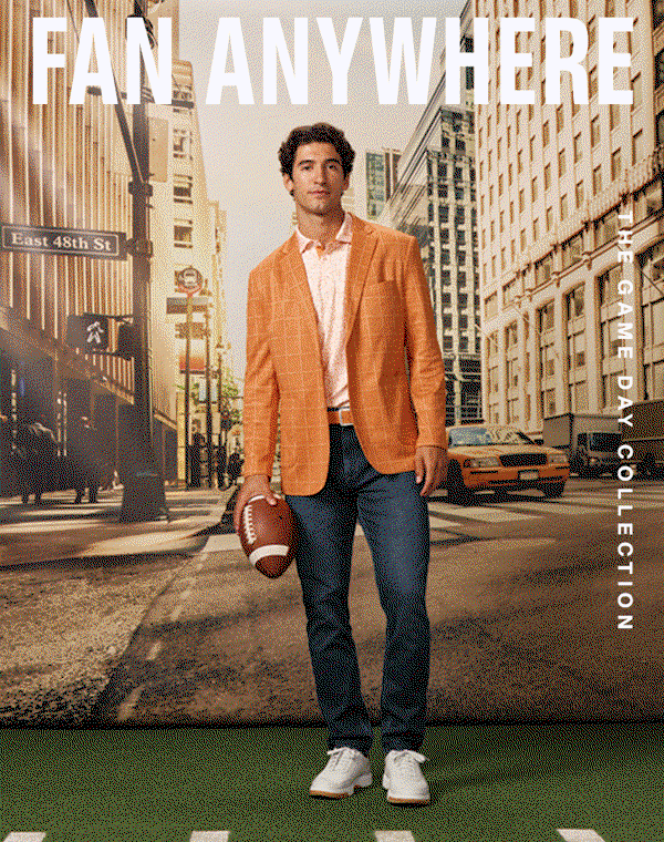 Model wearing an orange windowpane blazer, patterned polo, jeans, and white sneakers while holding a football on a city street. Text reads: 