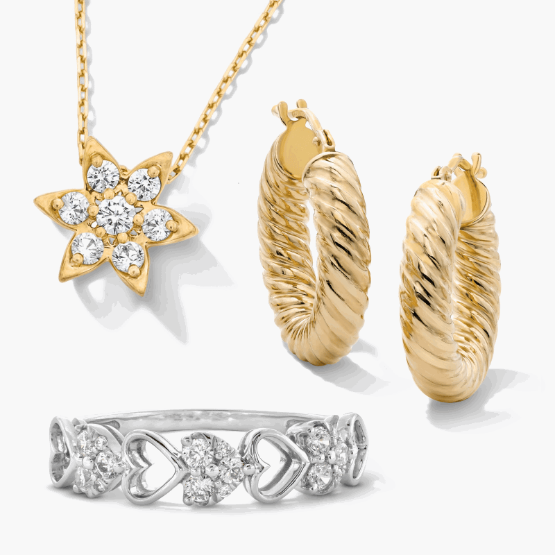 Yellow gold floral diamond pendant necklace, textured hoop earrings and diamond heart band ring.