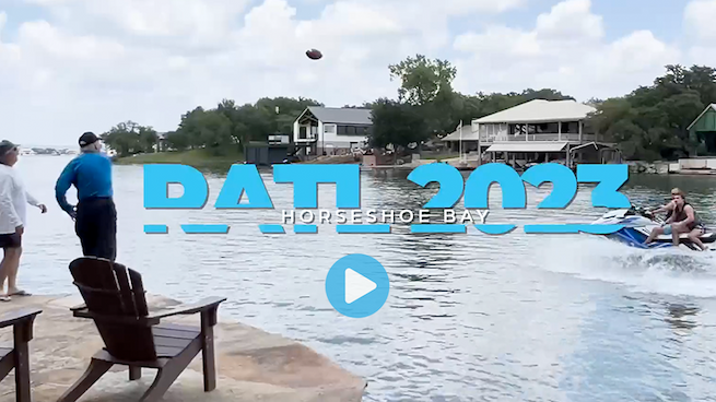 Man on dock throwing football to jetski passenger